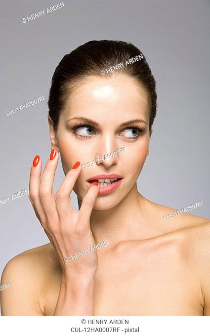 Female beauty model with finger in mouth