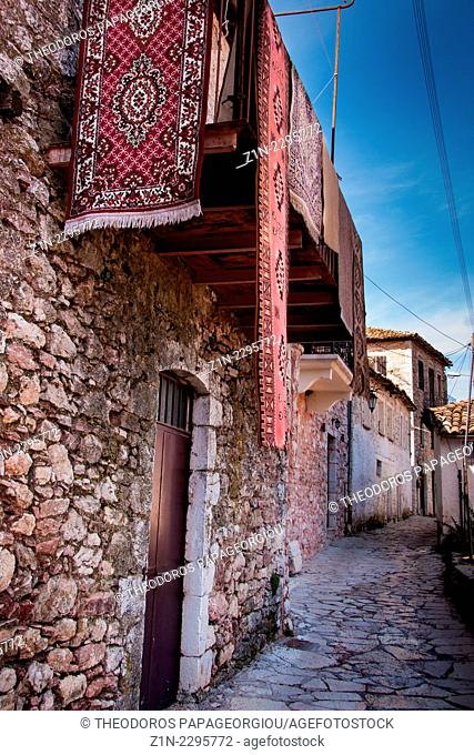 Carpets on a balcony over an alley. Dimitsana town, Arcadia, Peloponnese, Greece