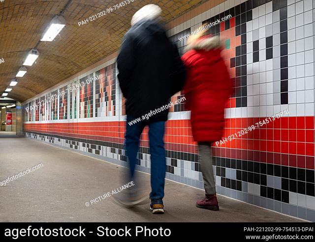 02 December 2022, Berlin: Passers-by walk through the pedestrian tunnel at Wannsee station, newly designed by illustrator Christoph Niemann