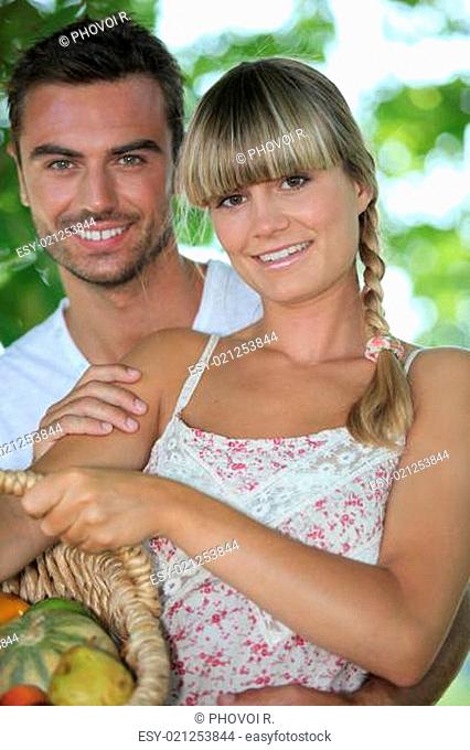 Couple in park with vegetable basket