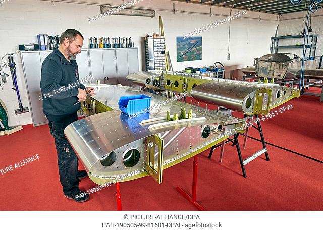 20 March 2019, Rhineland-Palatinate, Mendig: Roland Aircraft employees assemble aircraft in the company's hangar. Many private individuals fulfil their dream of...