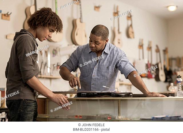 Father and son in music workshop