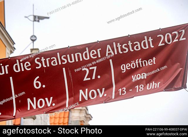 06 November 2022, Mecklenburg-Western Pomerania, Stralsund: An advertising poster hangs in the old town. The Hanseatic city offered another open Sunday in the...