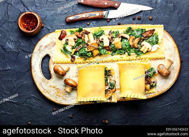 Lasagne with mushrooms, champignons, cheese and spinach. Traditional Italian food