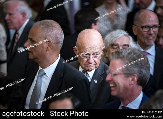 James Clapper, former Director of National Intelligence, center, following a ceremony with former US President Barack Obama and former first lady Michelle Obama...