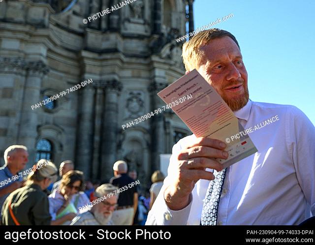 04 September 2023, Saxony, Dresden: Michael Kretschmer (CDU), Prime Minister of Saxony, is on the move at the event ""Gastmahl für alle"" under the motto...