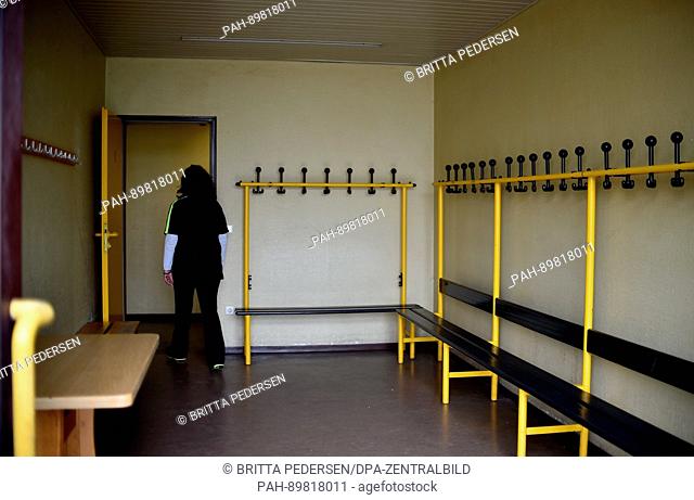 Mirela Puljic, treasurer of the BFC Germania 1888 soccer club, walks through the changing room at the BFC Germania 1888 soccer club in Berlin, Germany