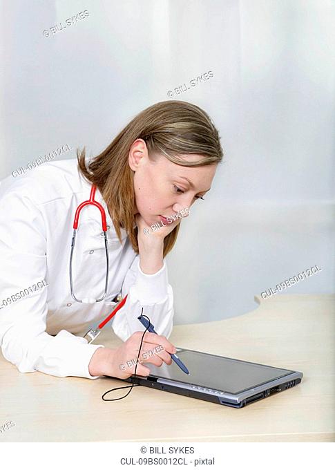 Female doctor using tablet pc