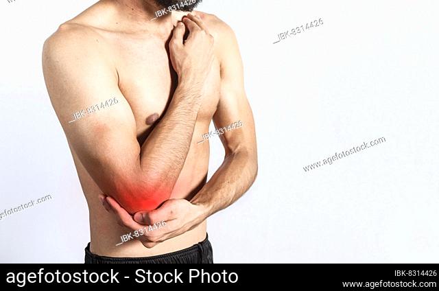 Person with elbow pain, concept of a man with rheumatism elbow pain, man massaging sore elbow, man with elbow cramp