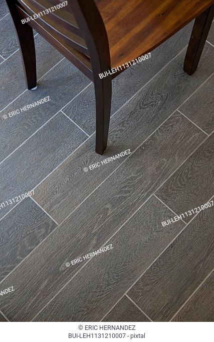 Detail shot of parquet floor with cropped chair at home
