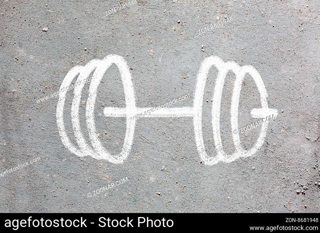 Funny barbell drawn on the gray wall