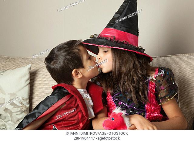 Children kissing on Halloween party