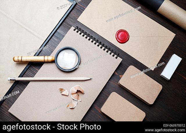 Photo of blank vintage stationery set on wooden background. Corporate identity template. Responsive design mockup. Flat lay