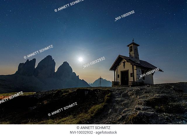 Tre Cime di Lavaredo with chapel at night, Tre Cime Natural Park, Dolomites, South Tyrol, Italy