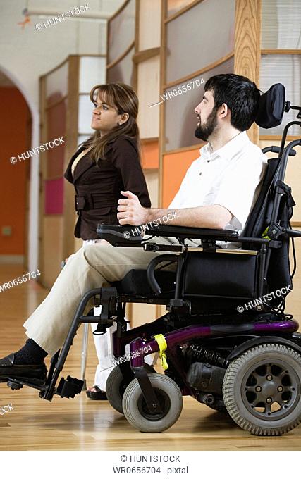 Side view of a handicapped man and woman