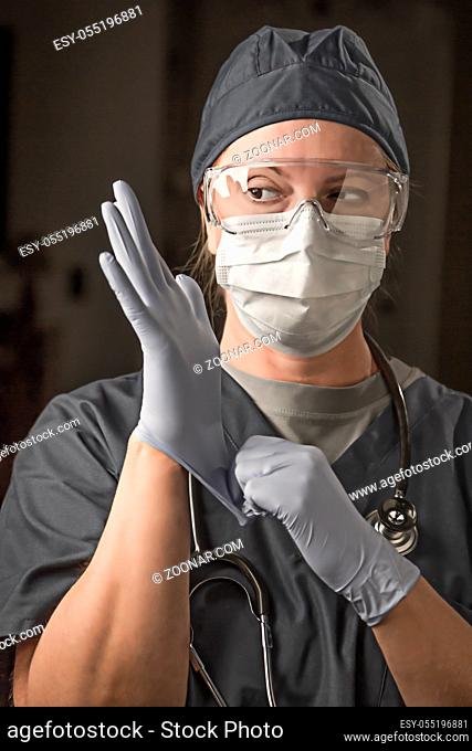 Female Doctor or Nurse Wearing Scrubs, Protective Face Mask and Goggles