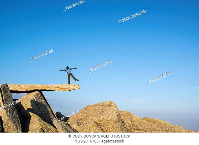 Female hiker on Cantilever stone, Glyder Fach, Snowdonia national park, Wales