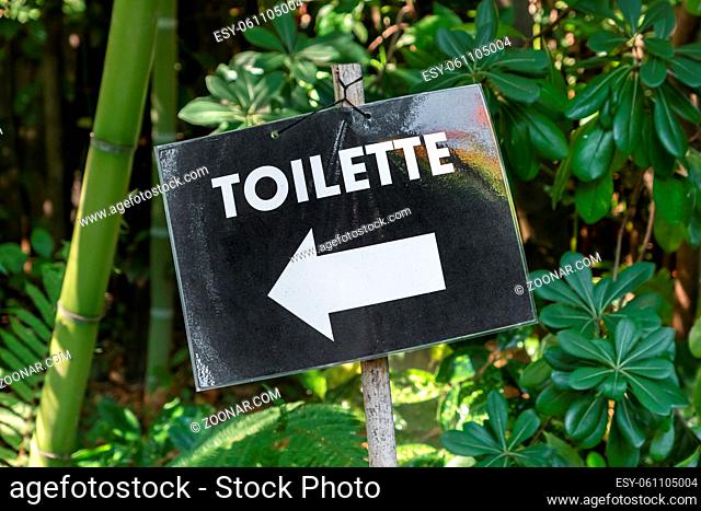 Plastic toilet sign with trees background. WC signpost for restroom