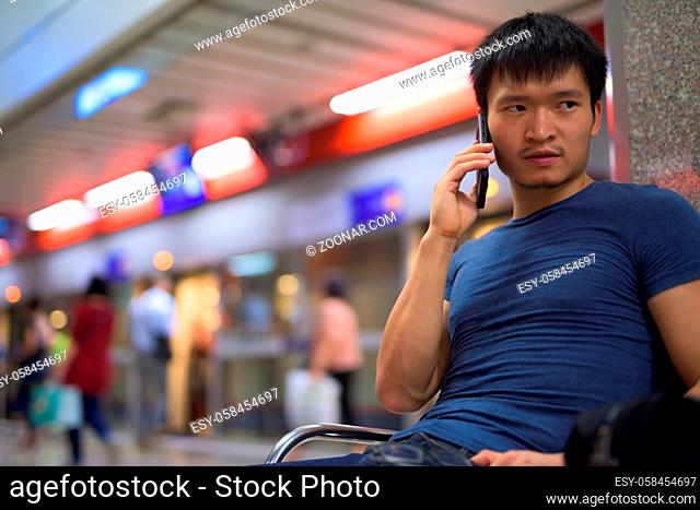 Portrait of young Chinese man at the subway station in the city