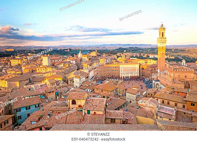 Siena aerial sunset panoramic skyline. Mangia tower and Campo square landmark. Tuscany, Italy