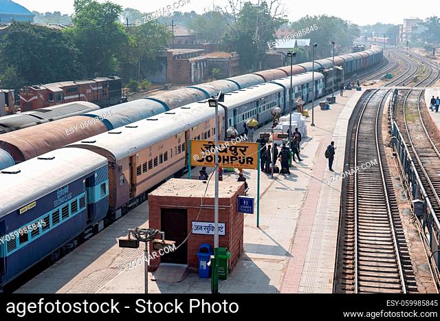 Jodhpur, India - December 10, 2019: Trains and people on a platform at the train station
