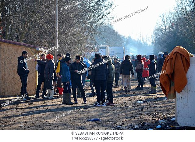 Refugees standing on an open space in Grande-Synthe, France, 19 January 2016. For months, several thousand people have been living in the Northern French...