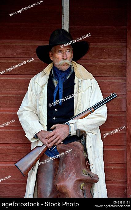 Portrait of Cowboy with Rifle, Shell, Wyoming, USA
