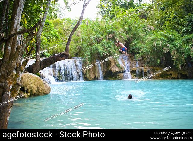 Tourist Swimming at the Kuang Si Waterfalls, Luang Prabang, Loas. The Kuang Si Waterfalls are located just outside Luang Prabang and are great for a day out