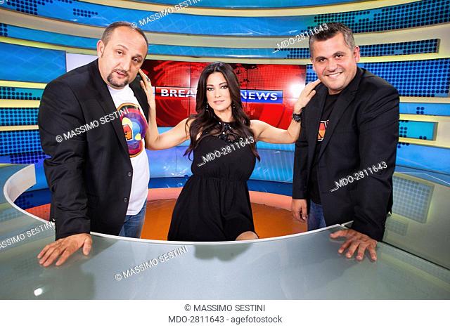 Saimir Kodra, the presenter Manuela Arcuri and Gent Zenelli during a photo shooting in the television studios of Agon Channel. Albania, Tirana