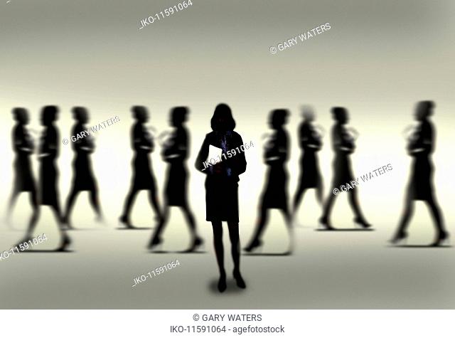 Silhouette of calm confident businesswoman standing out from the crowd