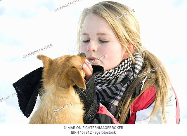 Girl, teenager with a small dog, winter