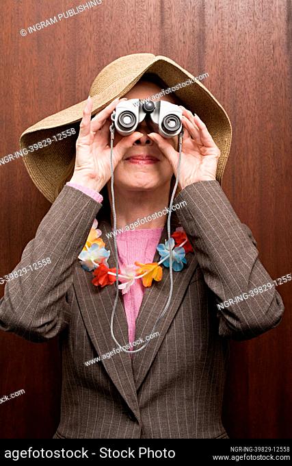 Business woman looking through binoculars