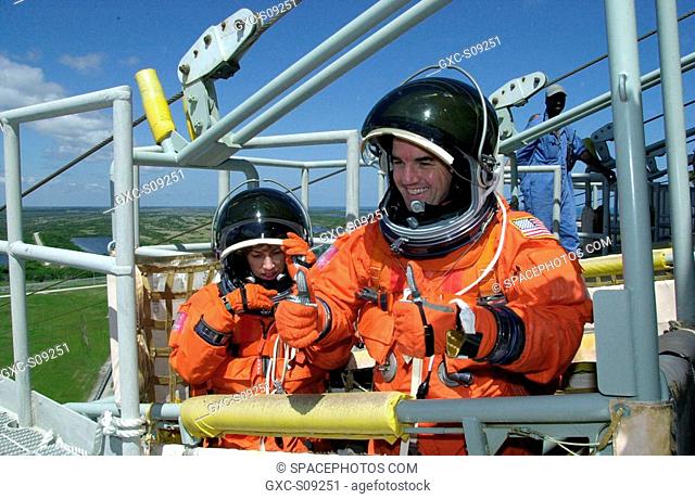 03/19/2002 -- STS-110 Mission Specialists Ellen Ochoa and Rex J. Walheim are in the slidewire basket, part of emergency egress equipment on the launch pad