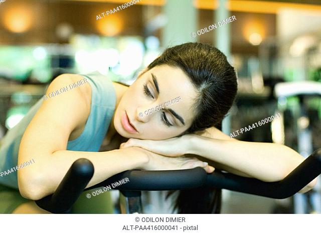 Woman resting on exercise bike