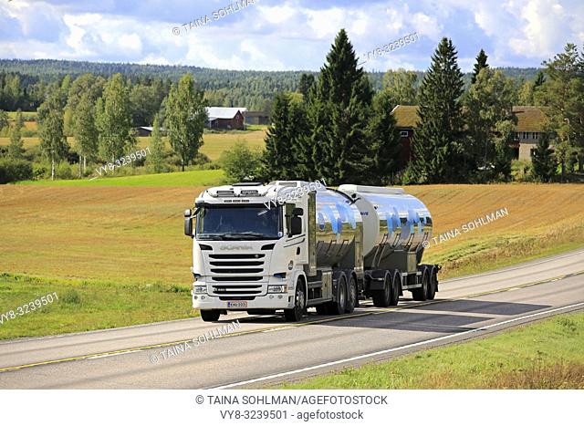 Jamsa, Finland - August 27, 2018: Scania R450 milk tanker of Jalonen transports Valio milk on road through country scenery on a beautiful summer day