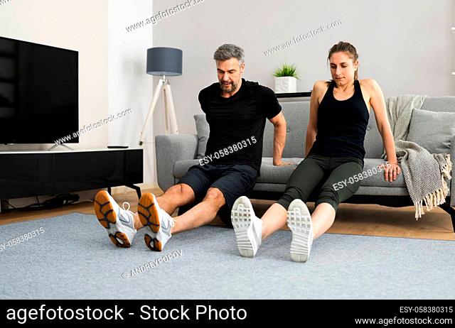Couple Doing Home Fitness Workout And Exercise