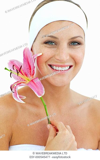 Delighted woman holding a flower against a white background