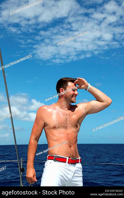 Man enjoying summer time holiday on sailing boat