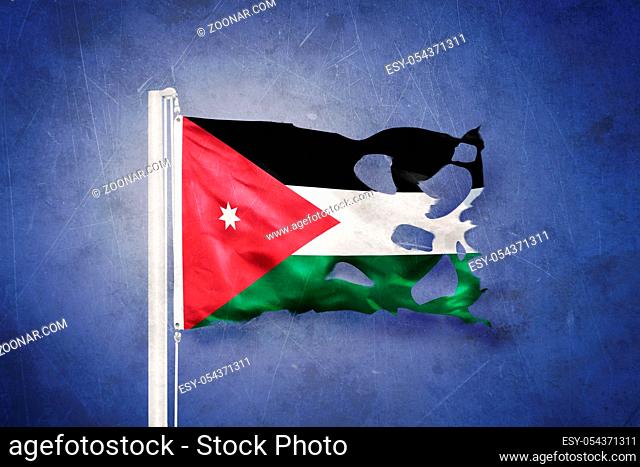 Torn flag of Jordan flying against grunge background