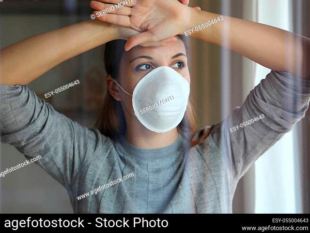COVID-19 Pandemic Coronavirus Woman Home Isolation Quarantine Wearing Mask Protective Against SARS-CoV-2. Quarantine girl with mask on face against Coronavirus...