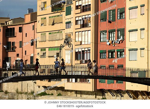 PEOPLE CROSSING FOOTBRIDGE CASAS PENJADES ONYAR RIVER GIRONA CITY CATALONIA SPAIN