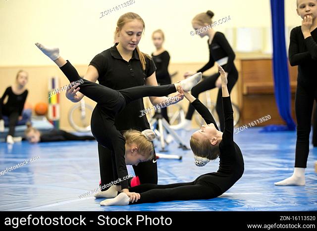 Belarus, Gomel, July 4, 2018. Indicative training circus school.Gymnastic workout for children. The coach stretches the child to the gymnastic twine