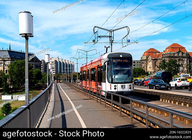 Dresden, Saxony / Germany - 3 September 2020: a tram crosses the Elbe River and Carola Brdige in Dresden