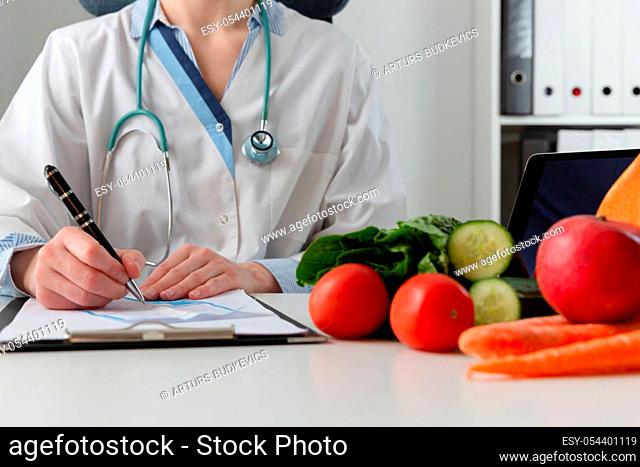Vegetable diet nutrition and medication concept. Nutritionist offers healthy vegetables diet. In a natural light