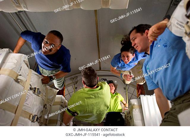 NASA astronauts Alvin Drew (left), Steve Bowen (center) and Nicole Stott (second right), all STS-133 mission specialists; along with NASA astronaut Cady Coleman...