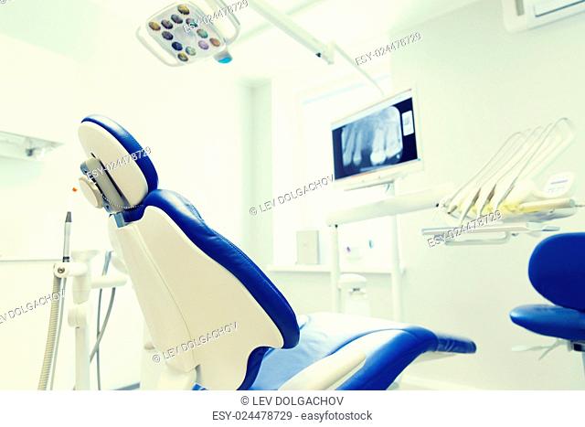dentistry, medicine, medical equipment and stomatology concept - interior of new modern dental clinic office with chair