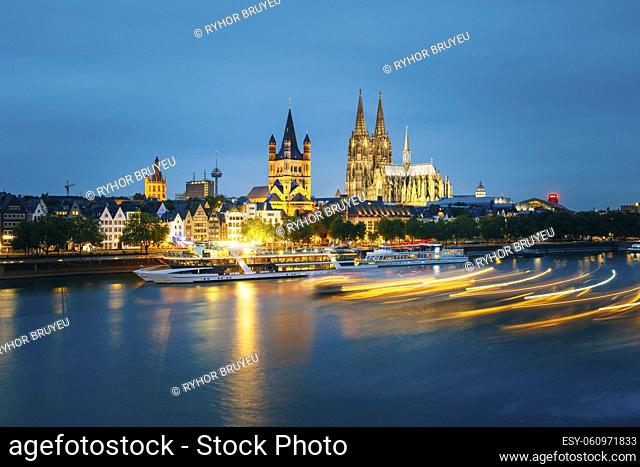 Great St. Martin Church And Dom In Cologne At Evening With Reflection In River Rhine In Cologne, Germany