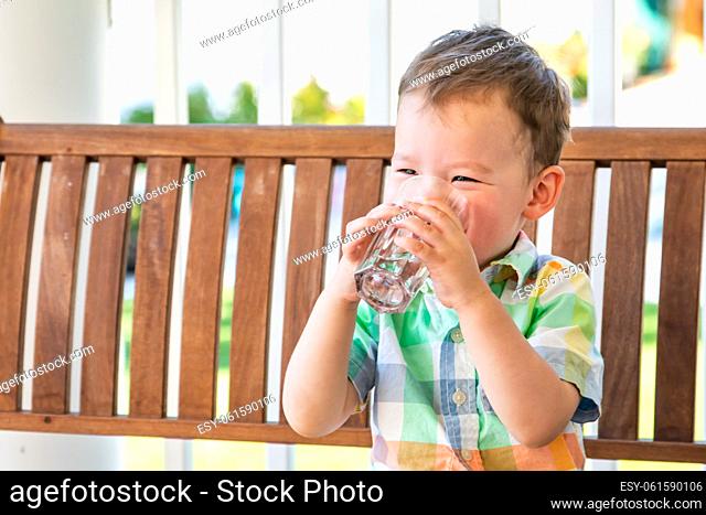Mixed Race Chinese and Caucasian Boy Enjoying A Glass Of Water