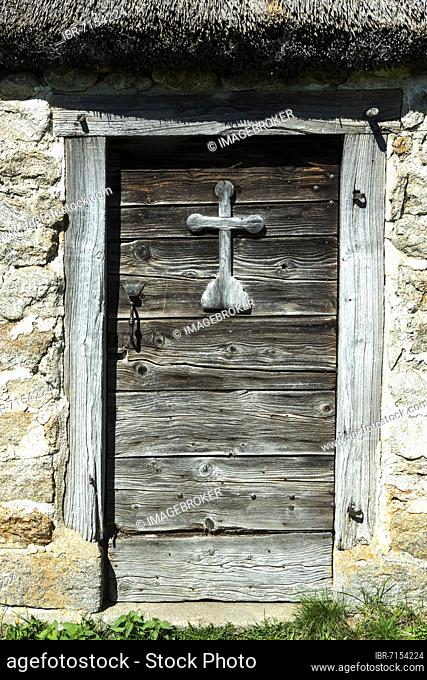 Wooden cross on a door of farm (jasserie), summer pasture specific to the Forez mountains at col of Supeyres, Livradois-Forez regional natural park