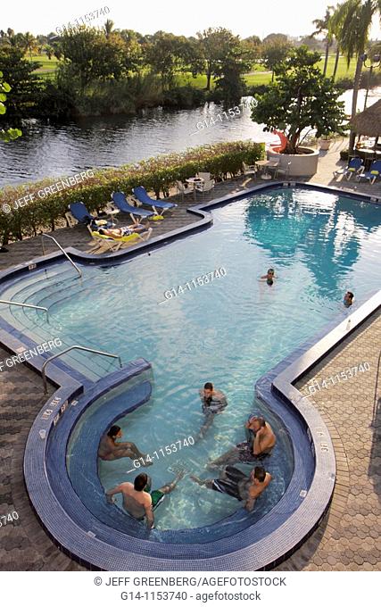 Florida, Miami, Wyndham Miami Airport Hotel, chain, lodging, exterior, pool, deck, lounge chair, man, men, swimming, guest, canal, golf course, relax, leisure